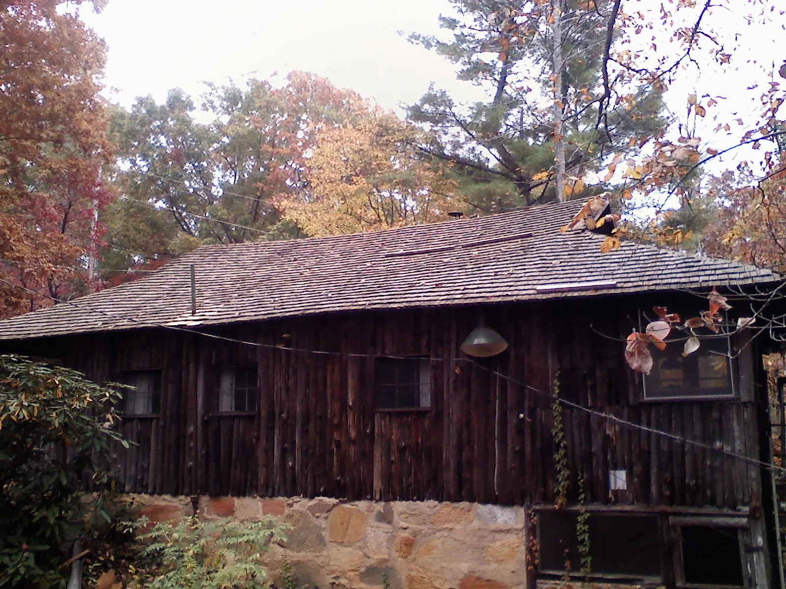 Weathered wood shake roof on a rustic board sided cabin in Hackleburg